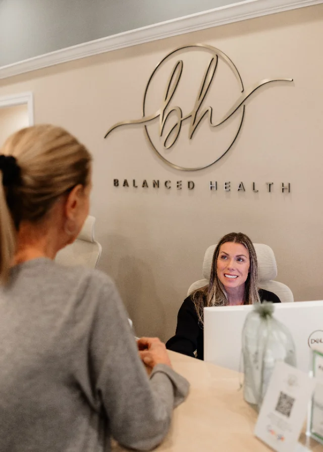 Two team members working together at the front desk